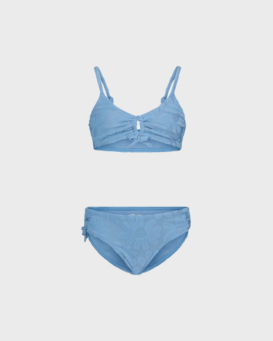 Blue bikini set on a light gray background