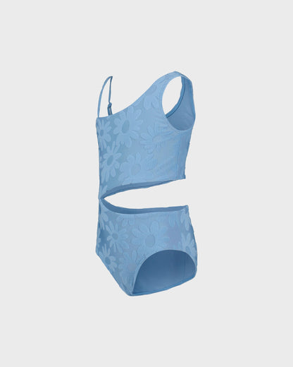 Blue swimsuit with cut-out design on a light gray background